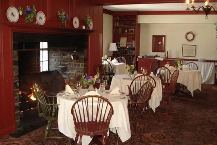 The old library with dining tables and a fireplace